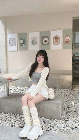 A woman sitting in a bright cafe lounge